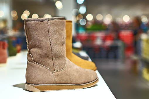 Ugg style light brown boots in a luxury store