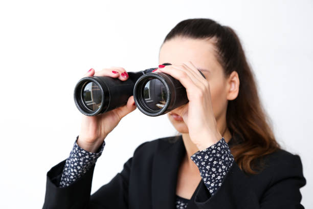 istock Girl on a white background looks through binoculars 846960248