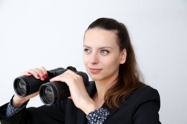 istock Girl on a white background looks through binoculars 846960264