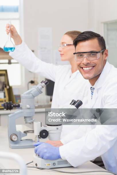 Scientists Examining Blue Precipitate Stock Photo - Download Image Now - 20-24 Years, 20-29 Years, 25-29 Years