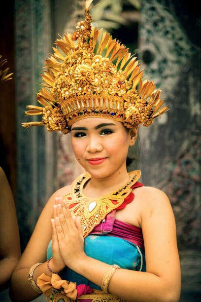 Bali, Indonesia - July 06, 2017. One traditional Balinese dressed girl welcoming the guests before the traditional Balinese dance show in Ubud Bali Indonesia. Illustrative editorial. At July 06 2017.