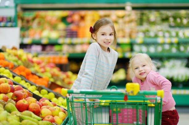 istock Two little sisters shopping in a food store 846972548