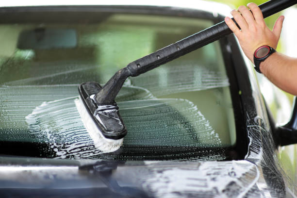 istock Using a brush to wash a car on a car washing facility 846972708