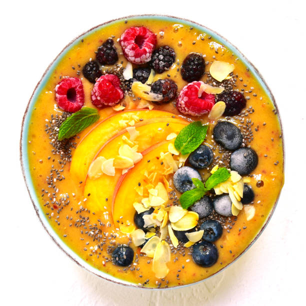 istock Colorful peach smoothie with wild berries and almond petals 846974876