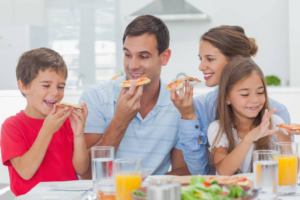 istock Happy family eating pizza slices 846978590