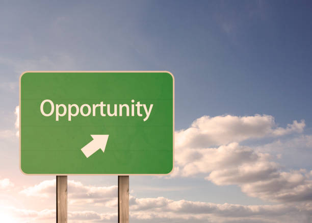 Opportunity road sign with clouds behind
