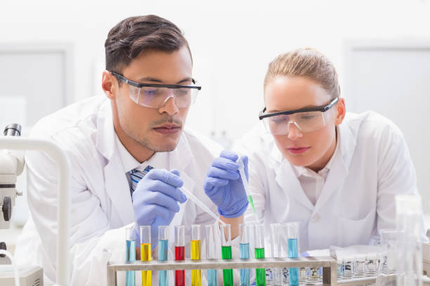 istock Focused scientists examining test tube 846990348