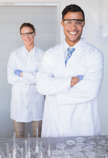 istock Smiling scientists looking at camera arms crossed 846993332