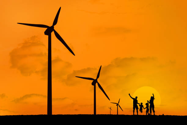 windkraftanlagen und familie springen mit einem sonnenuntergang - fuel and power generation power wind power supply stock-fotos und bilder