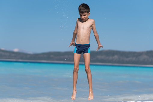 Hapy boy enjoying  at the lake of the salda Turkey.
