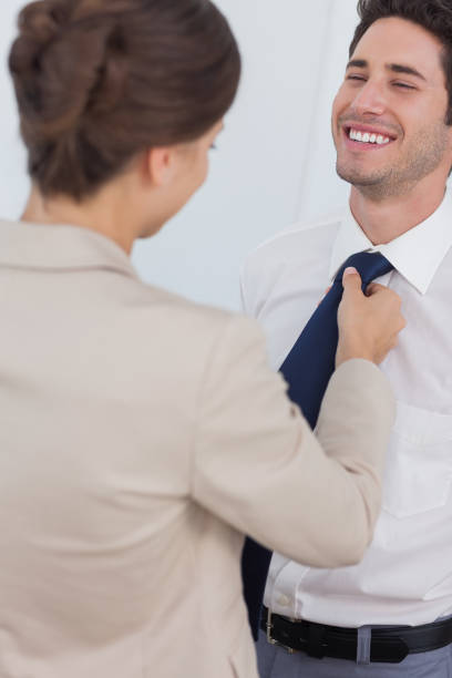 istock Woman helping her smiling husband to tie his tie 847002276