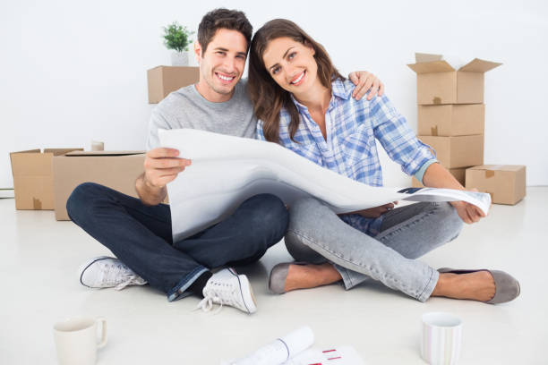 istock man and woman holding house plans 847002438