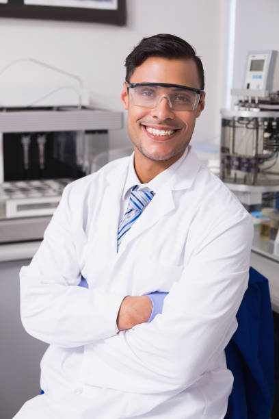 istock Happy scientist smiling at camera with arms crossed 847006262