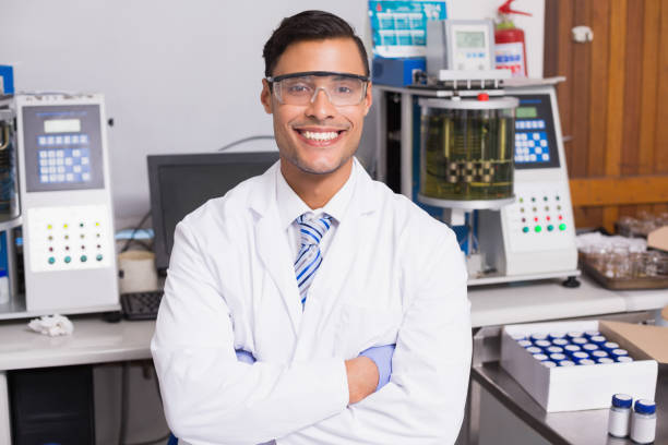 istock Happy scientist smiling at camera with arms crossed 847006280