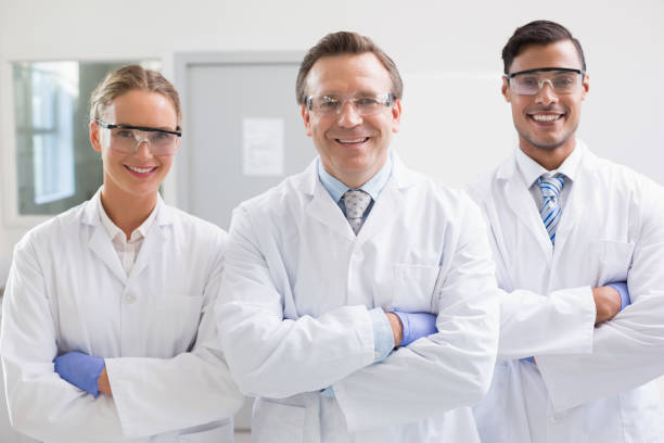istock Smiling scientists looking at camera arms crossed 847008528