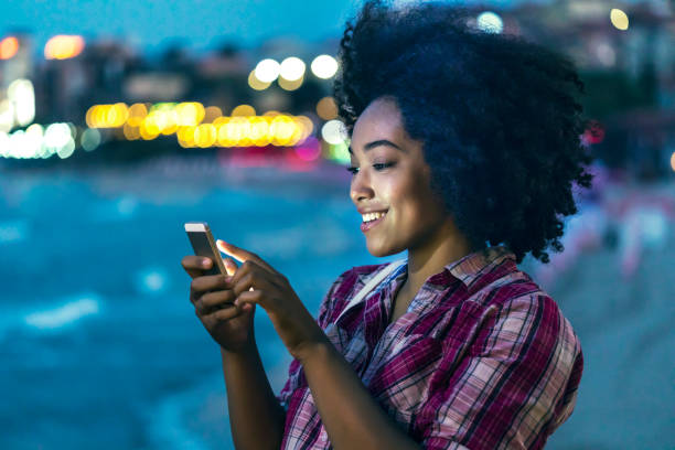 istock Woman using smart phone on street at night 847009766