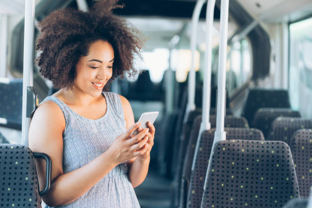 istock Cheerful woman traveling in bus and using smart phone 847011982