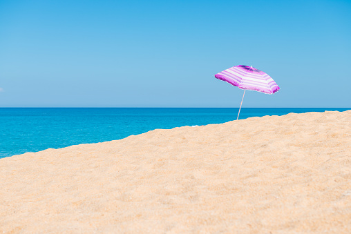 Violet parasol , purple umbrella on the beach at sunny day phuket thailand