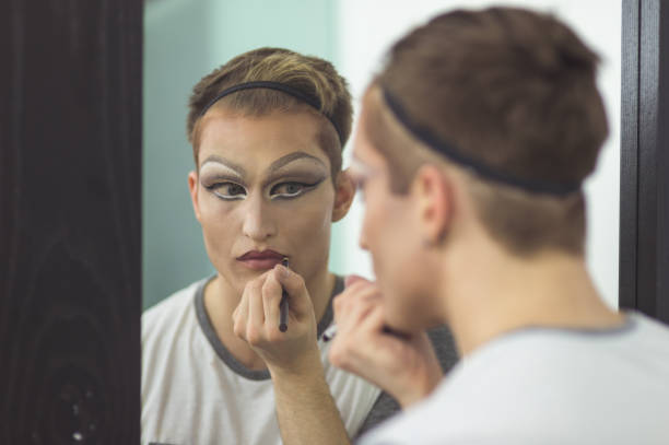 istock Man gets dressed in drag attire in bathroom 847012716