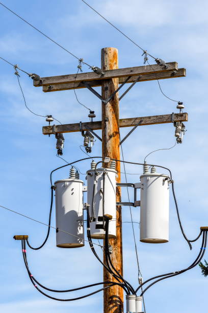 Wooden electricity pole with transformers Wooden electricity pole with transformers utility pole with power lines close up stock pictures, royalty-free photos & images
