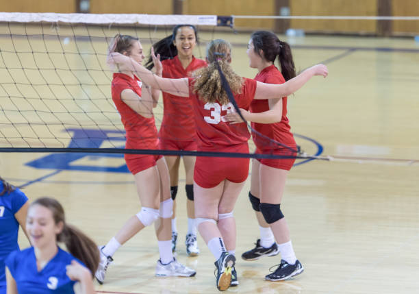istock Female high school volley ball team celebrating 847012952