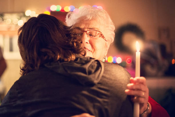 Grandmother and grandson celebrate Christmas and happy new year together. They celebrate the feasts in a parish hall of their region. The atmosphere is festive and filled with tenderness and love. The picture was taken in Quebec Canada during winter. They embracing one each other.