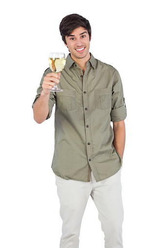 Young man holding wine glass and looking at the camera