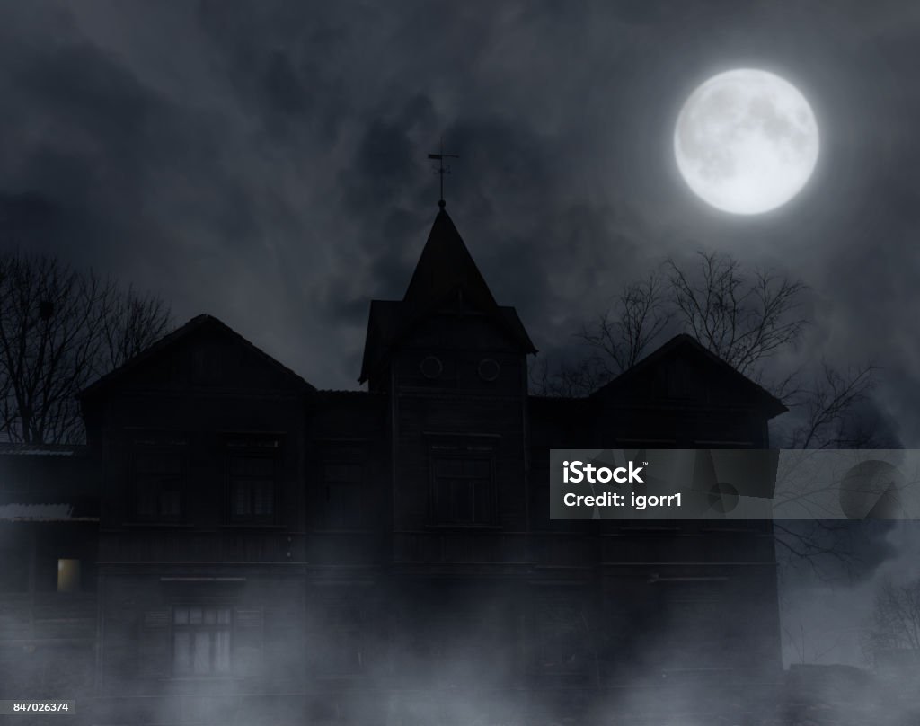 Abandoned wooden house. Abandoned wooden house in the moonlit night.Halloween background. House Stock Photo