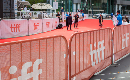 The Red Carpet at the Toronto International Film Festival with people in the background getting ready for the event to begin in Toronto, Ontario, Canada