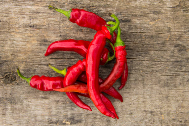 istock Red hot chili peppers on wooden table 847029682