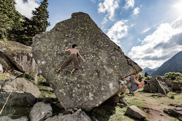 istock Woman and man practicing rock bouldering climbing 847032678