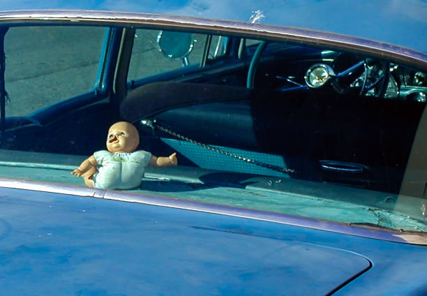 Trapped Noseless doll trapped in the rear of a car. blow up doll stock pictures, royalty-free photos & images
