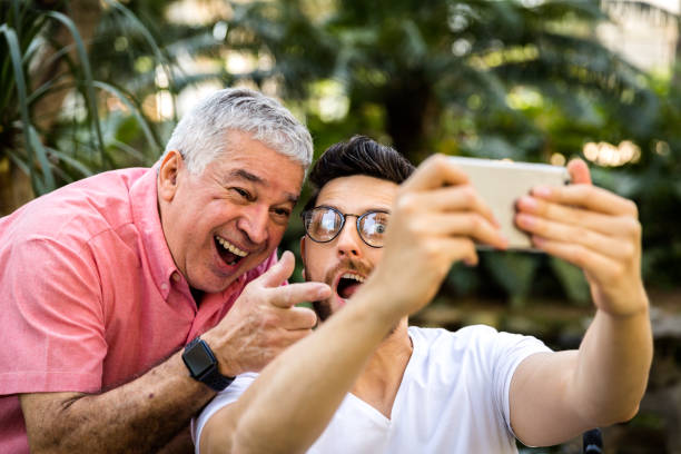 istock Dad and son taking selfie photo and having fun in the park 847033176
