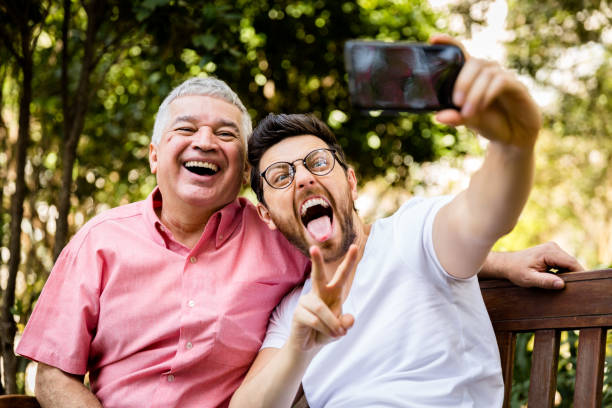 istock Dad and son taking selfie photo and having fun in the park 847033244