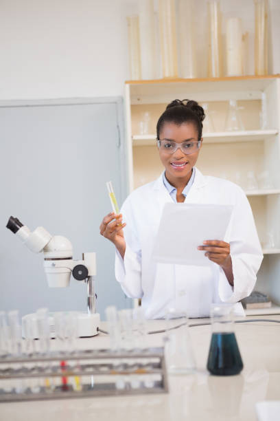 istock Smiling scientist looking at camera and holding paper 847037098