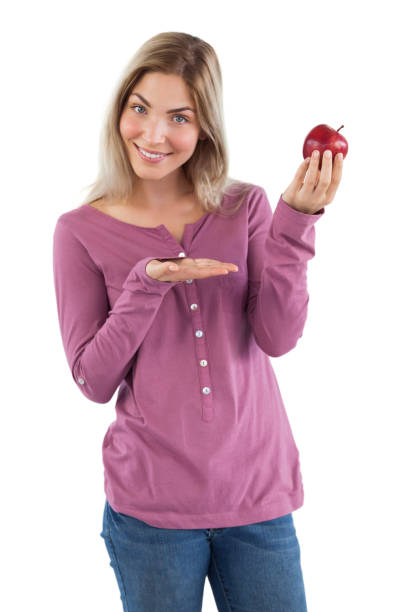 istock Blonde woman presenting an apple 847039268