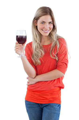 Smiling woman looking at the camera with red wine glass on a white background