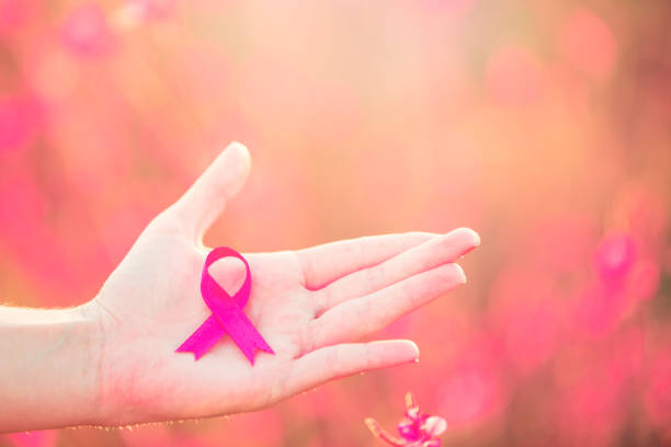 Holding pink breast cancer awareness ribbon