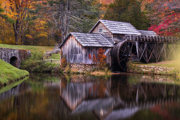 istock Old mill reflecting in mill pond in autumn 847039770