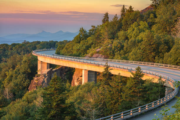 Morning light over viaduct, Blue Ridge Parkway morning light spills out on the Lynn Cove viaduct along the Blue Ridge Parkway in North Carolina. blue ridge parkway stock pictures, royalty-free photos & images