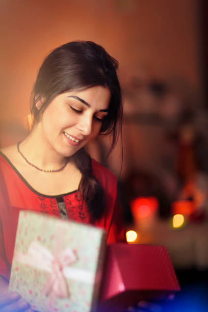 istock Woman opens Christmas gift 847039786