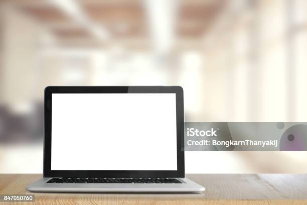 Mock Up Blank Screen Of Laptop On Wood Table In Coworking Or Office Stock Photo - Download Image Now