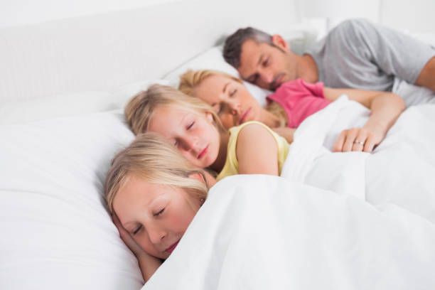 istock Parents sleeping with their children in bed 847058278