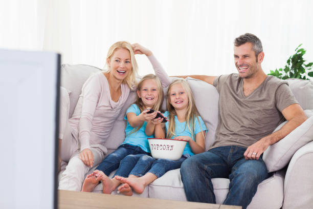 istock Twins and parents watching television 847058482