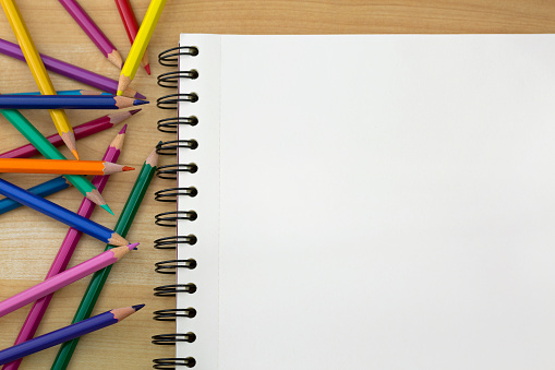 Coloring Colored Pencils Next To Sketch Drawing Book On Wooden Background  Stock Photo - Download Image Now - iStock