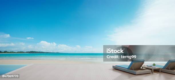 Sea View Swimming Pool Beside Terrace And Beds In Modern Luxury Beach House With Blue Sky Background Lounge Chairs On Wooden Deck At Vacation Home Or Hotel Stock Photo - Download Image Now