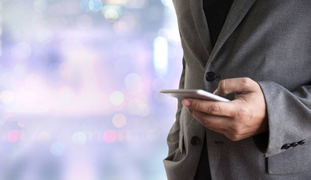 istock person holding a smartphone on blurred cityscape background 847069896