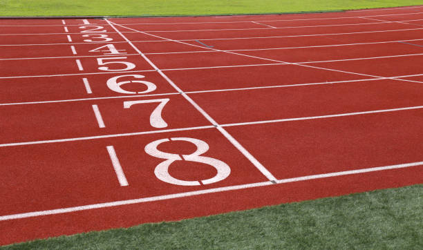 istock field run in stadium Red running  with lanes over sky 847069946
