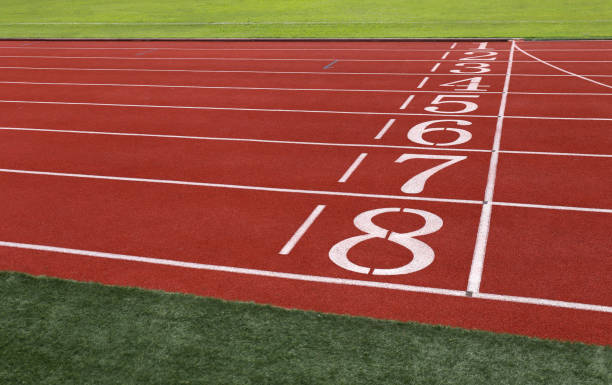 istock field run in stadium Red running  with lanes over sky 847070064