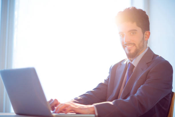 istock Businessman using laptop at desk 847070304